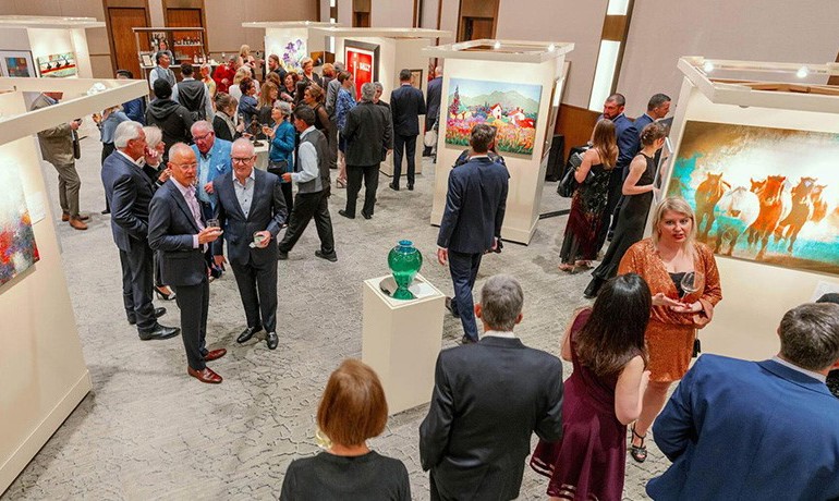 Guests mingle among artwork displays at the event