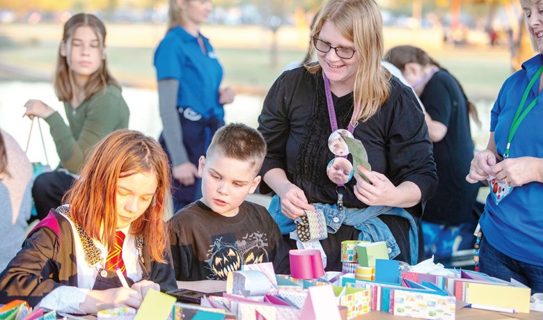 Katherine McKitrick with two children at remembrance event