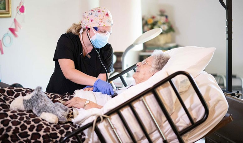 Nurse Bessie Medigovic attending to patient
