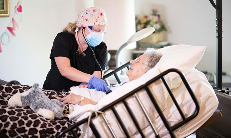 Nurse Bessie Medigovic attending to patient