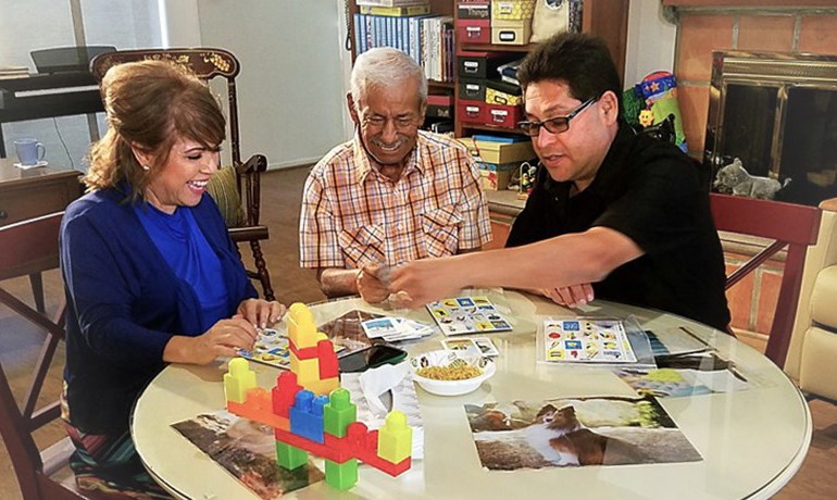 Volunteers playing board games with patients