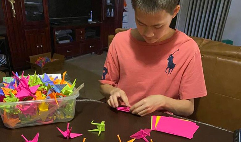 Charles Zhang folding paper cranes
