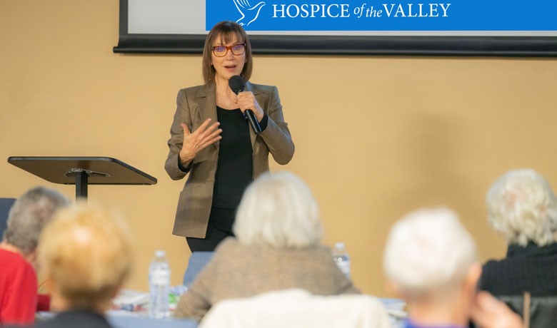 Maribeth Gallagher in front of audience with microphone