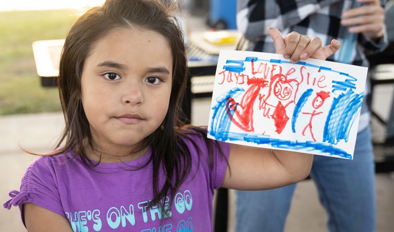 New Song Center child painting at event