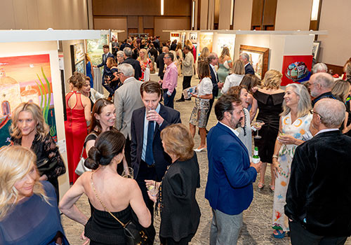People walking about art gallery at aaha annual event