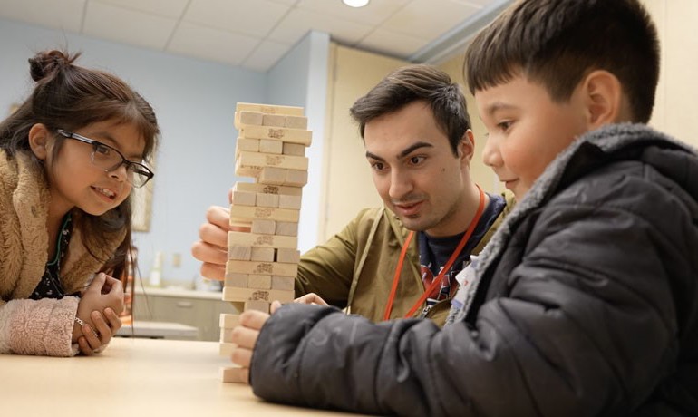 New Song children with college students