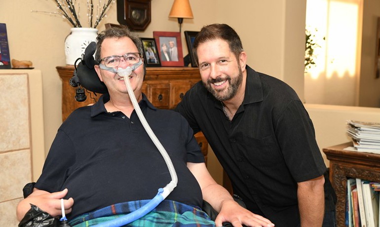 Patient companion sitting and visiting with patient