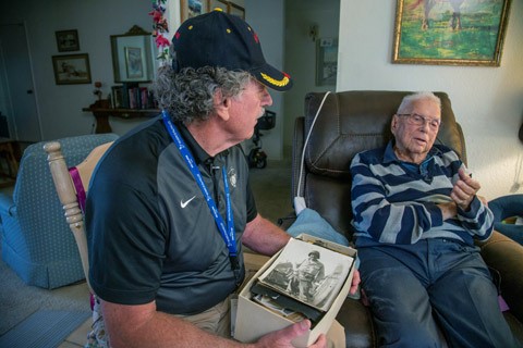 Chester Dorr and Rodney Dehmer look through old photos together