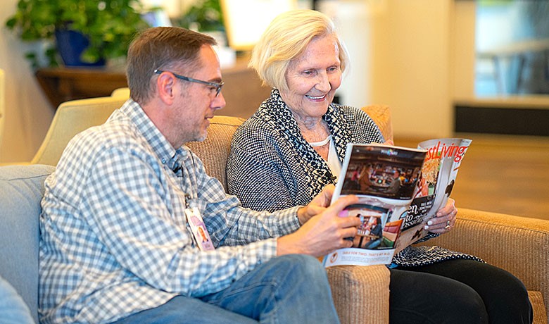 Volunteer reading to patient