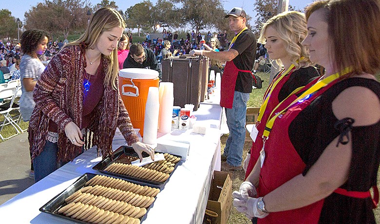 Volunteers handing out cookies at an event