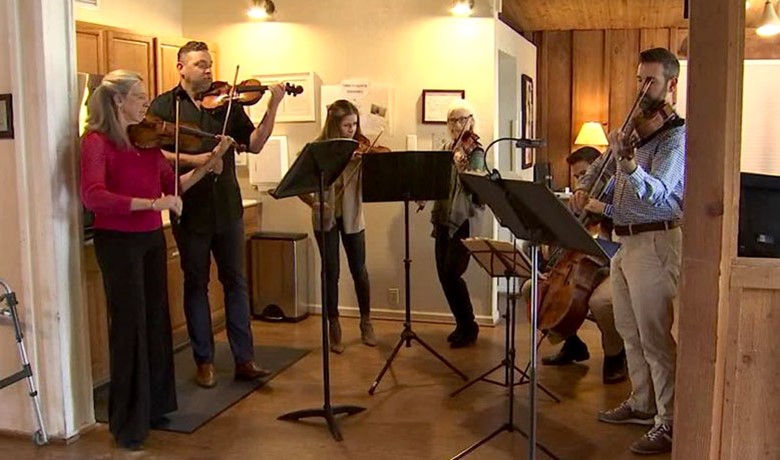 Six string musicians performing at Gardiner Home